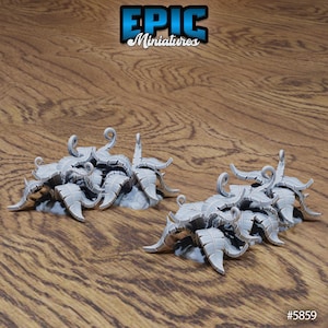 May include: Two gray miniature leaf clusters, possibly for tabletop gaming or model building, sit on a wooden surface. The leaves have detailed veining and a curled top. The Epic Miniatures logo is visible in the top center, and the number #5859 is in the bottom right.