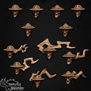 Könnte beinhalten: Ein Set mit 10 Miniatur-Schädelfiguren mit Hüten und Flammen. Die Schädel sind aus Metall gefertigt und haben eine Bronze-Oberfläche. Die Hüte sind in verschiedenen Formen und Größen, und die Flammen sind stilisiert und abstrakt.