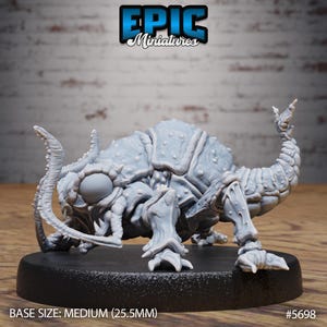 May include: A light grey miniature of a fantasy creature with a segmented body, multiple legs, and large mandibles. The miniature is on a black base. The text "EPIC Miniatures" is at the top, and "BASE SIZE: MEDIUM (2.55cm)" is at the bottom.