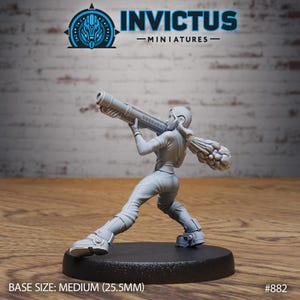May include: A gray miniature figure of a person aiming a large weapon. The figure is in a dynamic pose, wearing a jumpsuit and boots. The base size is medium, 25.5mm. The Invictus Miniatures logo is visible in the top left corner.