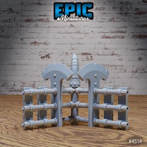 May include: A gray plastic model of a medieval gate with a pointed top and a series of horizontal bars. The gate is made up of two sections, each with a curved top and a pointed bottom. The gate is sitting on a wooden surface. #4514