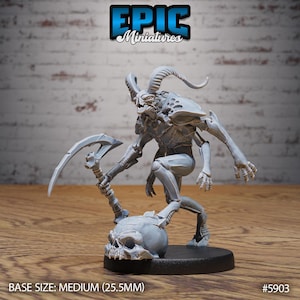 May include: A grey miniature demon figure with horns and a scythe, posed on a skull. The figure has detailed armour and is on a black base. The text "EPIC Miniatures" is at the top. Base size: Medium (25.5mm).