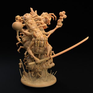 May include: A detailed, beige-coloured figurine of a woman with long hair, holding a sword and standing on a tree trunk with multiple faces and spider-like limbs. The figurine is set on a circular base.