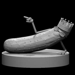 May include: A gray 3D printed model of a pickle wearing a crown and sunglasses, posing with one arm raised and pointing with the other hand. The pickle is lying on a gray base.