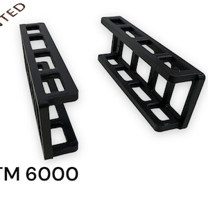 May include: Two black 3D printed plastic shelves with a grid pattern. The shelves are labelled "FTM 6000" and "3D PRINTED".