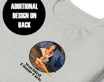 May include: A gray t-shirt with a black circle on the front that says "ADDITIONAL DESIGN ON BACK". The back of the shirt features a circular design with a woman in a white jacket and a brown leather jacket sitting on a plane. The text "Warbird Pinup Girls" is below the design.