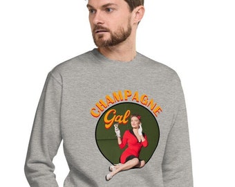 May include: A gray sweatshirt with a circular graphic of a woman in a red dress holding a glass of champagne. The graphic has the text "Champagne Gal" in orange.