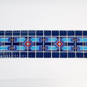 May include: A border of blue, turquoise, and red mosaic tiles with a geometric pattern. The tiles are arranged in a repeating pattern of squares and diamonds.