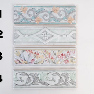 May include: Four different tile border designs with floral and geometric patterns. The tiles are in shades of white, gray, blue, green, yellow, and pink.
