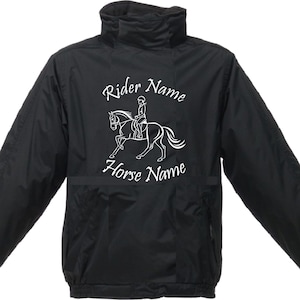 May include: Black jacket with a white graphic of a rider on a horse. The text "Rider Name" and "Horse Name" is printed on the jacket.