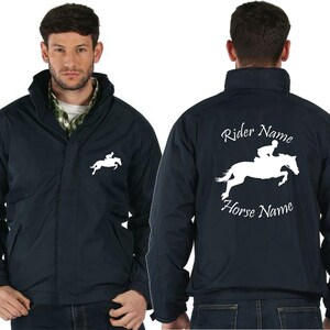 May include: A navy blue jacket with a white silhouette of a rider on a horse. The text "Rider Name" and "Horse Name" is printed on the back of the jacket.