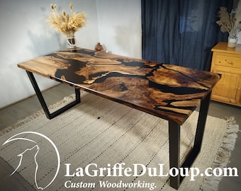 Custom-made dining tables in walnut wood of 350 years of age and black epoxy resin.