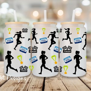 May include: Three glass tumblers with bamboo lids and straws. Each tumbler features a black silhouette of a runner, a marathon bib with the number 01234, a gold medal, and a checkered flag. The text "Finish" is also included.