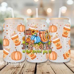 May include: Three frosted glass tumblers with bamboo lids and straws. The tumblers feature a fall-themed design with pumpkins, coffee cups, sunflowers, and the text "Just a Girl Who Loves Fall". The tumblers are decorated with orange and brown colors.