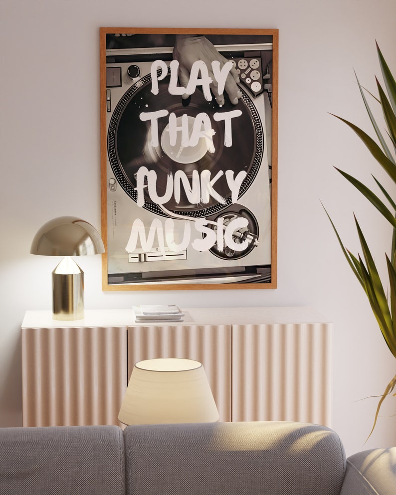 May include: A framed black and white photograph of a hand on a turntable with the text "PLAY THAT FUNKY MUSIC" written in white paint.