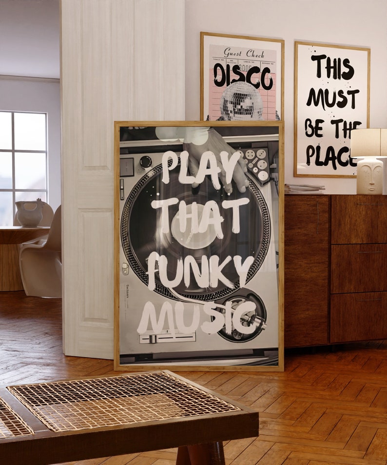 May include: A framed poster with a black and white image of a turntable with the text "PLAY THAT FUNKY MUSIC" in white paint.