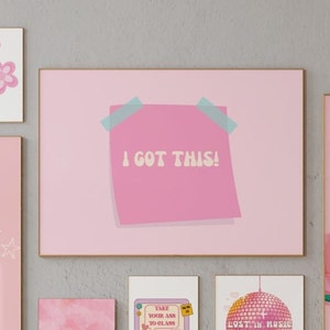 May include: Pink framed print with a pink sticky note that says "I got this!" in a retro font. The print is surrounded by other pink framed prints with various designs.