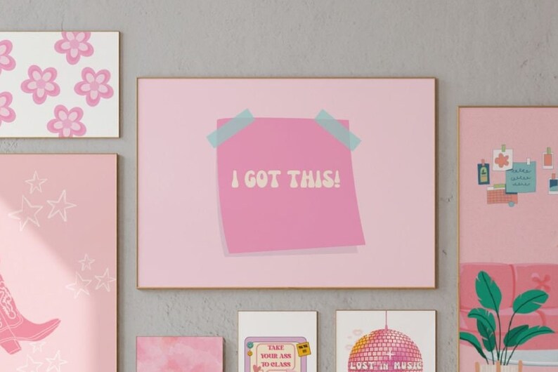 May include: Pink framed print with a pink sticky note that says "I got this!" in a retro font. The print is surrounded by other pink framed prints with various designs.