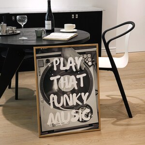 May include: A framed black and white photograph of a turntable with the text "PLAY THAT FUNKY MUSIC" written in white paint.