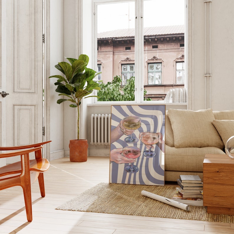 May include: A framed print of a colorful illustration of four hands holding up glasses of wine against a background of blue and white wavy lines.