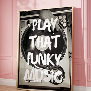 May include: Black and white photo of a turntable with a hand on the tonearm. The text "PLAY THAT FUNKY MUSIC" is written in white paint on the turntable.