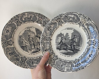 Pair of French antique Sarreguemines "talking plates" c 1890, musical theme with town crier and lads having fun, black transferware