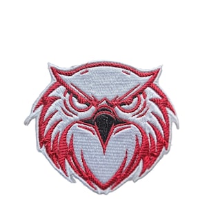 May include: Red embroidered owl face patch with white stitching. The owl has a fierce expression with sharp eyes and a beak.