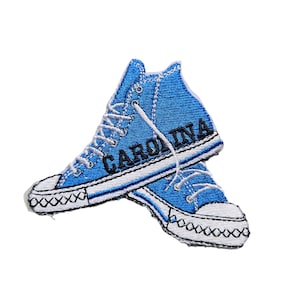 May include: Blue embroidered patch of a pair of high-top sneakers with the word "CAROLINA" written on the side.