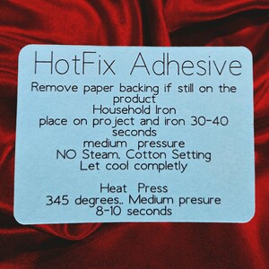 May include: Blue instruction card with the text "HotFix Adhesive" and instructions for using a household iron to apply the adhesive. The instructions include the temperature and pressure settings for the iron, as well as the time to apply heat.