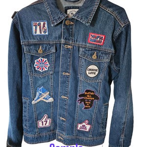 May include: A blue denim jacket with various patches, including a "716", "Mafia Mama", "Choose Love", "Buffalo NLL Champs", and a thumbs up with "17" on it.