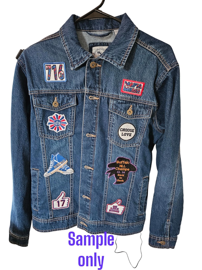 May include: A blue denim jacket with various patches, including a "716", "Mafia Mama", "Choose Love", "Buffalo NLL Champs", and a thumbs up with "17" on it.
