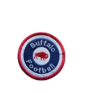 May include: A red, white and blue circular patch with the text "Buffalo Football" and a red buffalo silhouette.