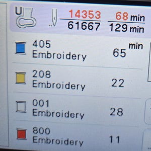 May include: A screen displaying embroidery design information. The screen shows four different embroidery designs with their corresponding stitch counts and estimated embroidery times. The designs are labeled with numbers: 405, 208, 001, and 800. The total embroidery time is 129 minutes.
