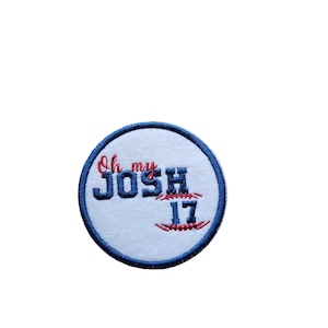 May include: A white round patch with a blue border. The patch has red and blue embroidery that says "Oh my JOSH 17".