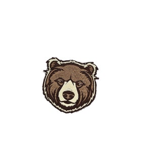 May include: Embroidered brown bear head patch with a white nose and eyes.