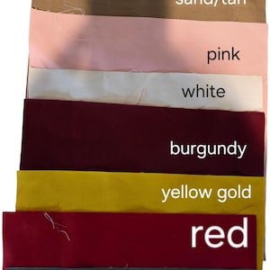 May include: A selection of fabric swatches in shades such as sand/tan, pink, white, burgundy, yellow gold, red, and navy blue. Each swatch is labelled with its colour name in white text.