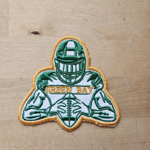 Embroidered Green Bay football player shaped iron on patch