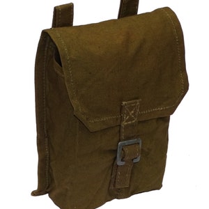 May include: Olive green canvas pouch with a flap closure and a metal buckle. The pouch has two loops on the back and is designed to be worn on a belt or attached to other gear. The stitching is visible and the overall design is simple and functional.