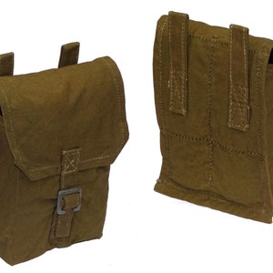 May include: Two olive-green canvas pouches with flap closures and metal buckles. The pouches have stitched detailing and belt loops on the back. One pouch is shown from the front and the other from the back.