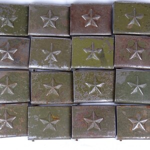 May include: A collection of 18 vintage metal belt buckles with a star design. The buckles are green and have a worn, rusty appearance.