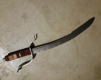 May include: A silver-colored sword with a brown leather wrapped handle. The sword has a curved blade and a decorative guard.