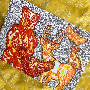 May include: A hand-drawn illustration of a bear, deer, owl, and moth. The animals are drawn in a swirling pattern of orange and yellow lines on a black and white background.