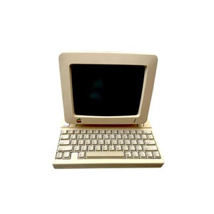 May include: An off-white vintage Apple Macintosh portable computer with a black screen and attached keyboard. The computer has the Apple logo on the front. The keyboard has a standard QWERTY layout.