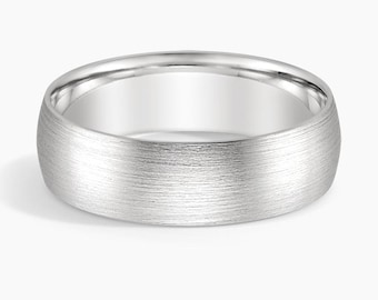 May include: A brushed silver wedding band with a rounded profile. The ring has a matte finish and a smooth interior. The band is approximately 6mm wide. This ring is a classic choice for a wedding or commitment ceremony.