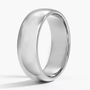 May include: A polished, silver-colored ring with a rounded, domed top and a smooth, reflective surface. The ring has a classic, simple design, and is set against a white background.