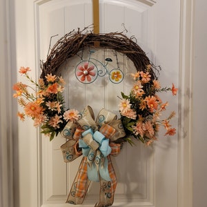 18 inch Welcome Grapevine wreath with Peach florals and teal bike