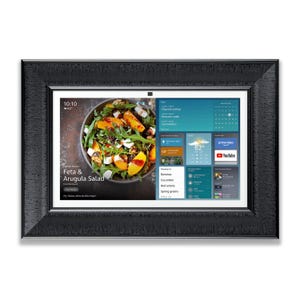 May include: A black framed digital photo frame showing a Feta & Arugula Salad recipe. The screen also displays the time, weather, and a calendar. The frame has a textured border. The temperature is 16.6 degrees Celsius.