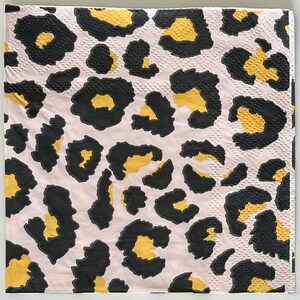 May include: Pink napkins with a black and gold leopard print design.