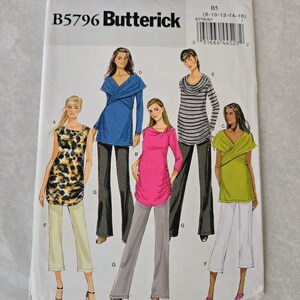 May include: A Butterick sewing pattern B5796 featuring illustrations of various women's tops. The tops include a blue wrap top, a pink ruched top, a striped cowl neck top, and a green wrap top. The pattern also includes illustrations of pants.