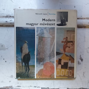 May include: A book titled "Modern magyar művészet" by Németh Lajos, published by Corvina. The cover features four abstract paintings in a collage style.